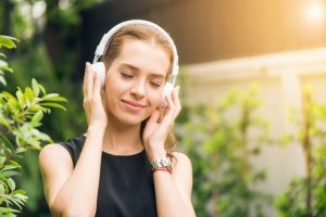 Woman listening to a recording of relaxing post-hypnotic suggestion