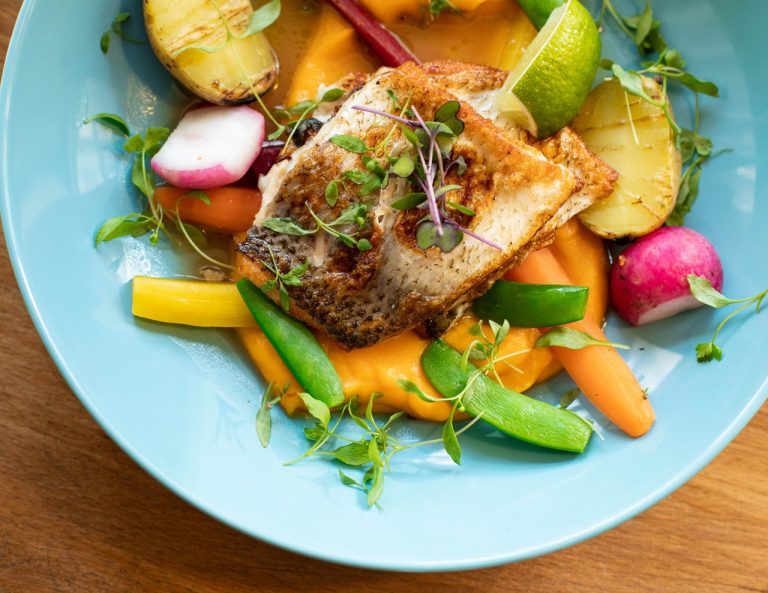 a plate of vegetables and fish